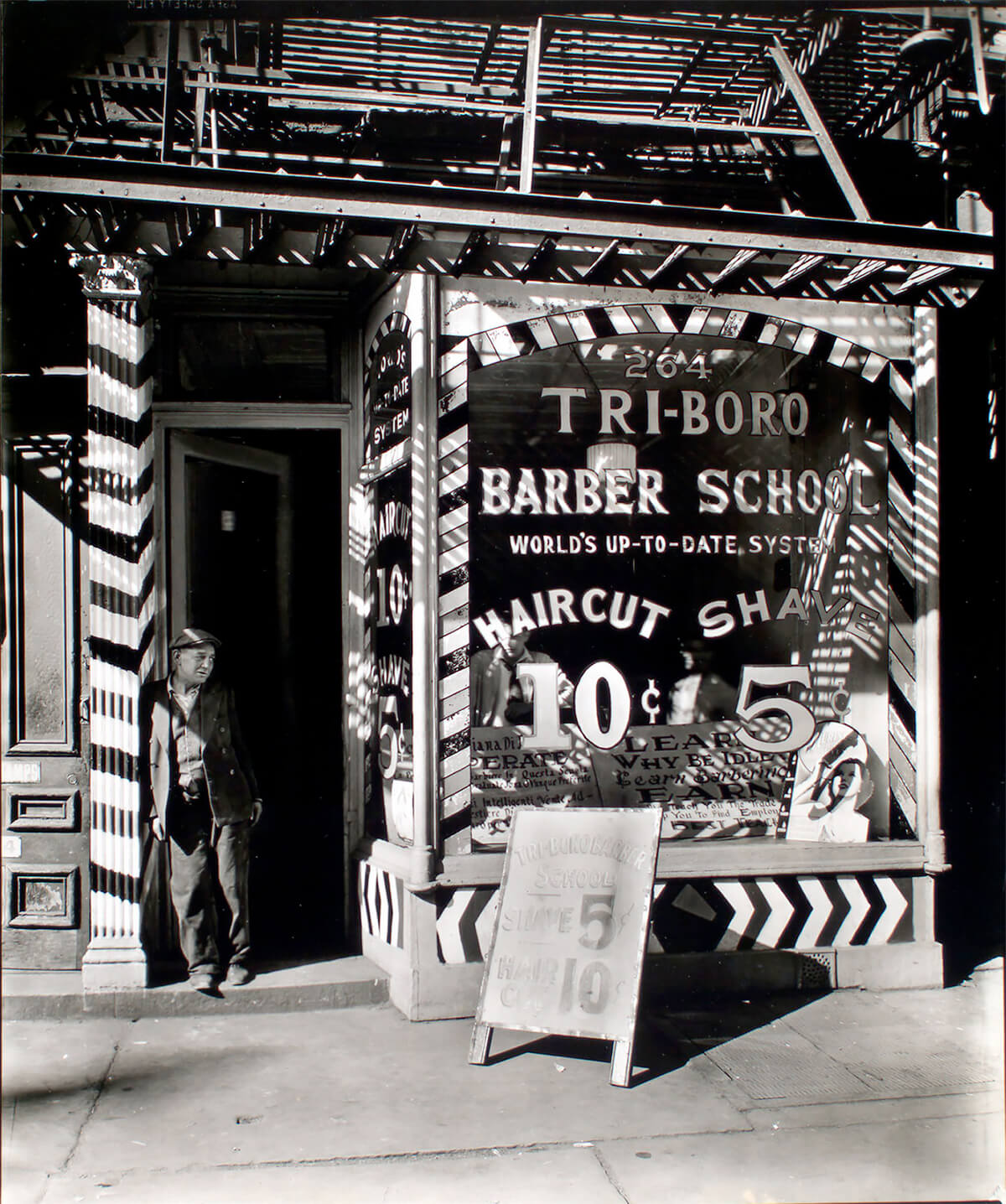Tri-boro Barber School, 264 Bowery, Manhattan, photograph by Berenice Abbott, 1935. ©New York Public Library<p>© Berenice Abbott</p>
