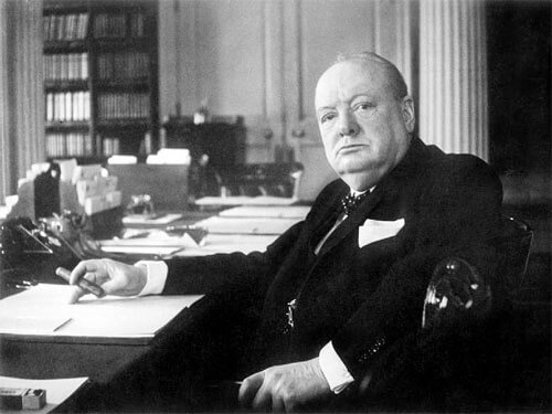 Winston Churchill at his seat in the Cabinet Room at No 10 Downing Street, London. © IWM Non Commercial Licence<p>© Cecil Beaton</p>