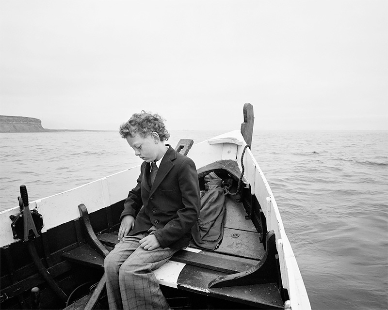 Simon Coultas being taken to sea for the first time since his father drowned, Skinningrove 1984<p>© Chris Killip</p>