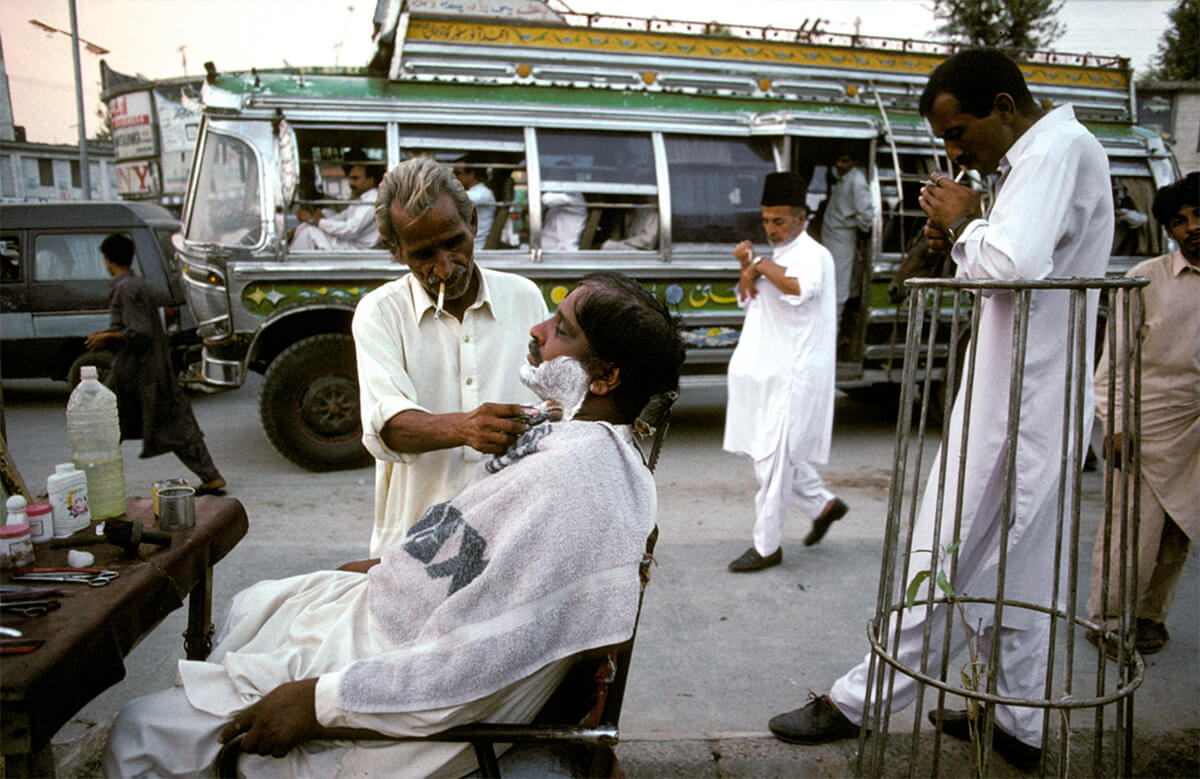 Pakistan Encountered. Mohamed Sadiq, 60, a barber for 40 years, runs business in Fawara Chauk (Fountain Square) in city of Rawalpindi, 1998.<p>Courtesy VII Photo Agency / © Ed Kashi</p>