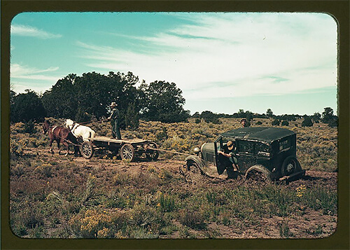 A horse-and-cart team pulling a car out of the mud on a road near Pie Town, New Mexico, in late 1940.<p>© Russell Lee</p>