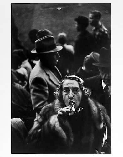 Woman drinking from bottle after game, Ebbetts Field, Brooklyn mid 1950s<p>Courtesy Trunk Archive / © Jay Maisel</p>