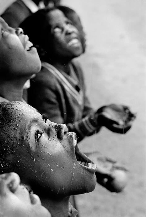 SOUTHERN AFRICA. Lesotho. School children during a rainstorm. 1981.<p>Courtesy Magnum Photos / © Chris Steele-Perkins</p>