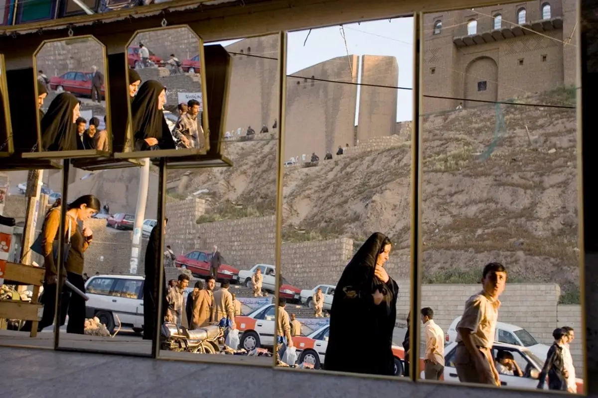 Mirrors in the Citadel Frame Shop, opposite Erbil’s historic citadel, reflect the movements and energy of this prospering and peaceful Kurdish city. IRAQ 2005⁣