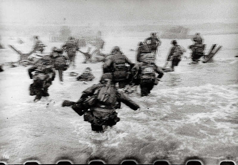 Robert Capa - American soldiers landing on Omaha Beach, D-Day, Normandy, France. June 6, 1944.