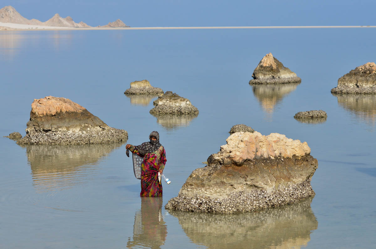 Detwah Lagoon, Socotra, Yemen on the 8th of May 2014. Sadiya holds a black sea creature in the coral reef. <p>© Amira Al-Sharif</p>