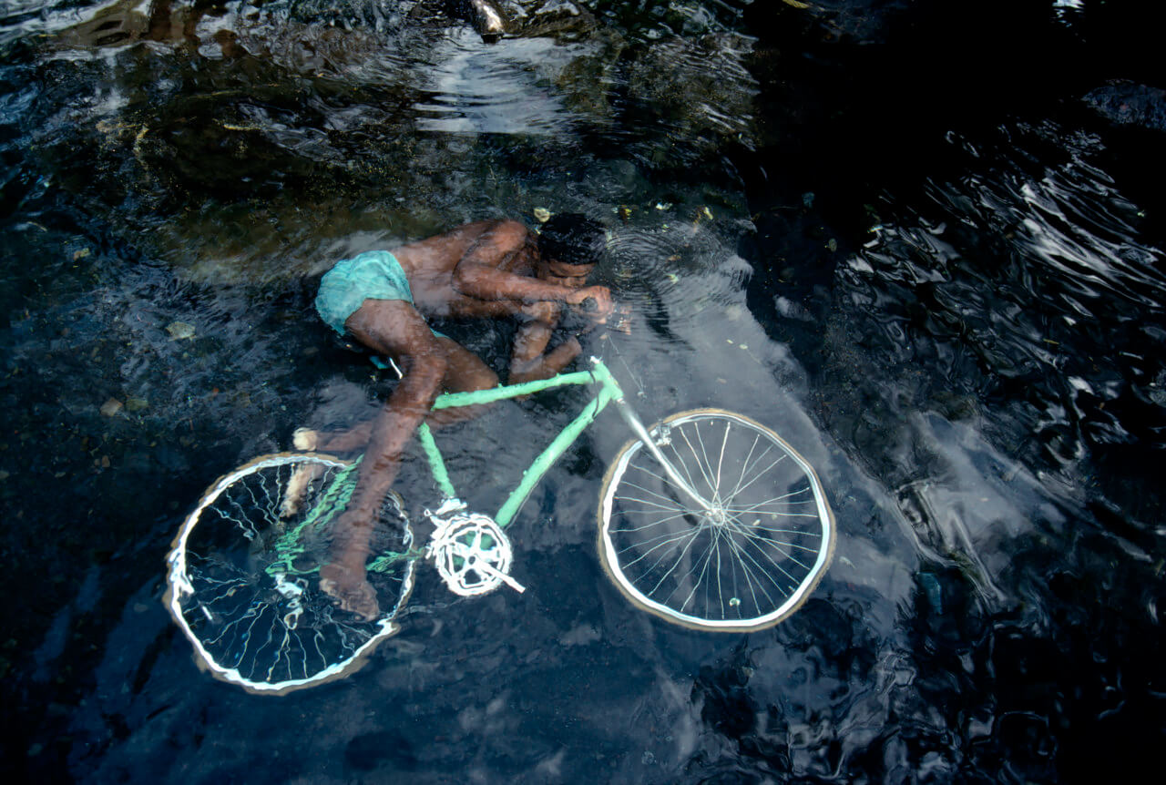 A boy plays in the Riviere of Galets, Reunion 1991<p>Courtesy Magnum Photos / © Bruno Barbey</p>