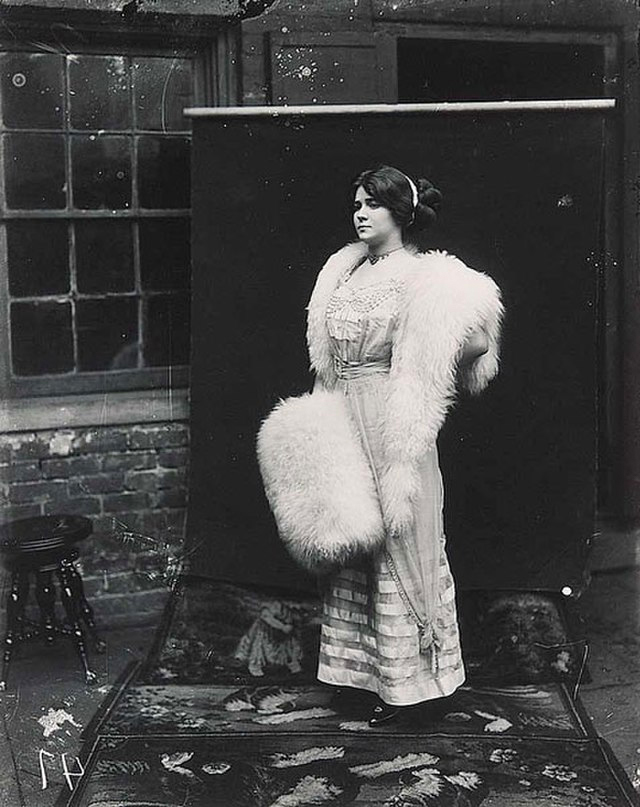 Photograph of Storyville prostitute, by E. J. Bellocq, circa 1912. ”Storyville Girl Posing Out of Doors” with backdrop.<p>© E. J. Bellocq</p>