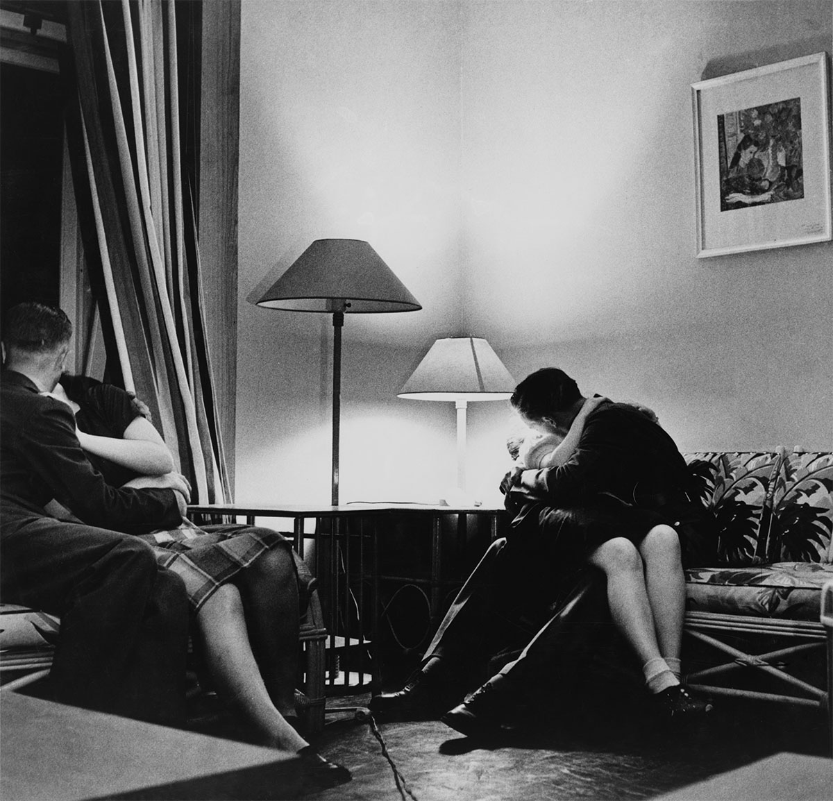 Photo of two couples separately engaging in kisses. Caption: ”Arlington, Virginia. Girls entertaining their guests in one of the two card rooms, at a <p>© Esther Bubley</p>