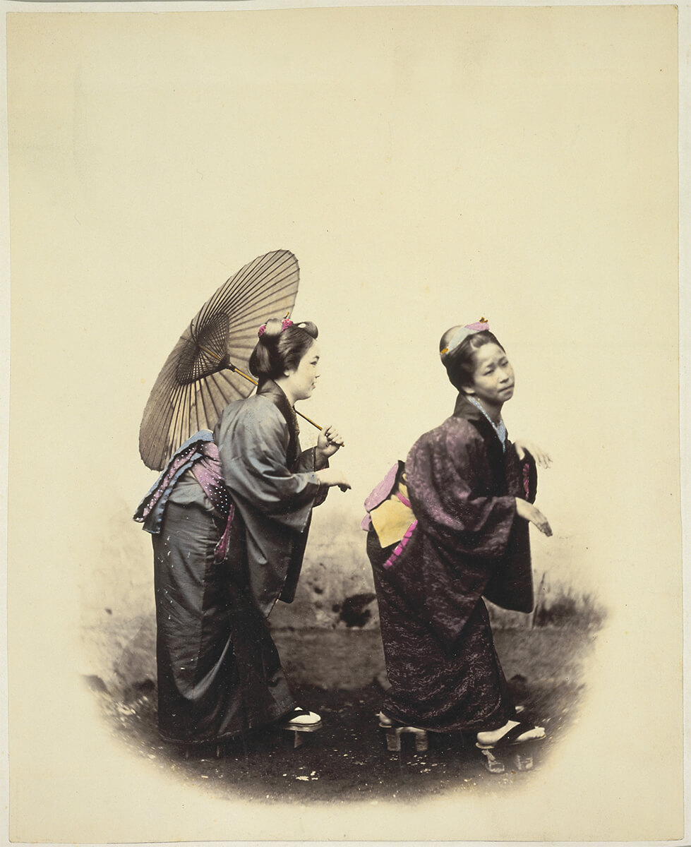 Two women with a parasol, in traditional costume and footwear, Japan, taken between 1867 and 1869<p>© Felice Beato</p>