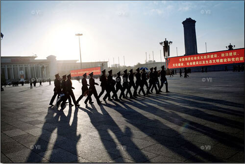 Chinese military walk in formation across Tiananmen Square just seconds after they detained scores of people, Beijing.<p>© Marcus Bleasdale</p>