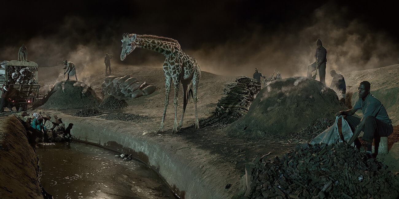 This Empty World - Charcoal burning with Giraffe and Worker<p>© Nick Brandt</p>