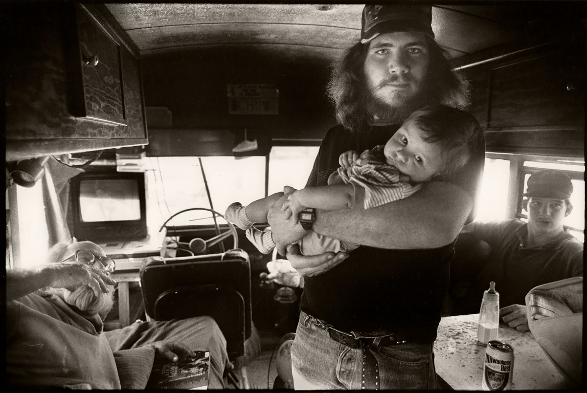Father and Son, Family of 9 Living in a School Bus, Fall City, WA 1992<p>© Saul Bromberger</p>