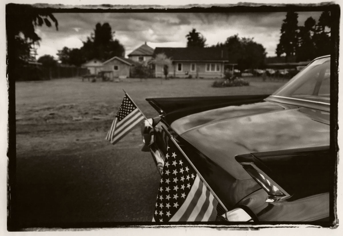Cadillac with American Flags - The Fourth of July, Carnation, WA 1994<p>© Saul Bromberger</p>