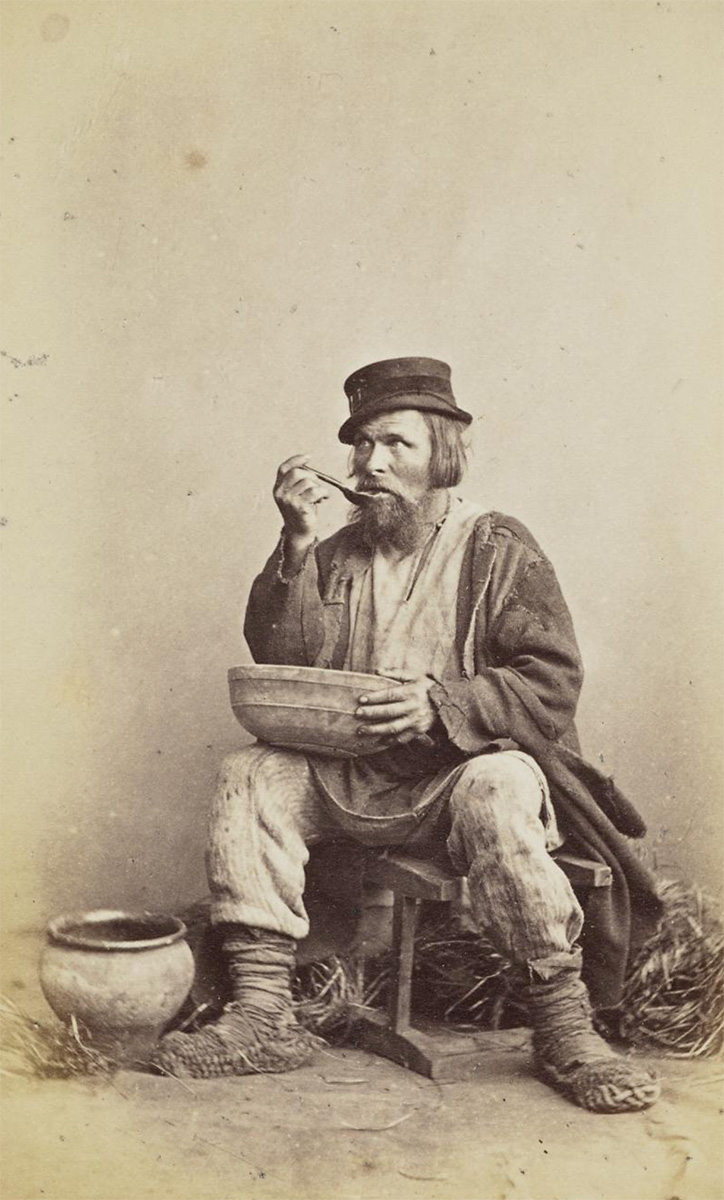 Russian ’type’ peasant eating from a bowl<p>© William Carrick</p>