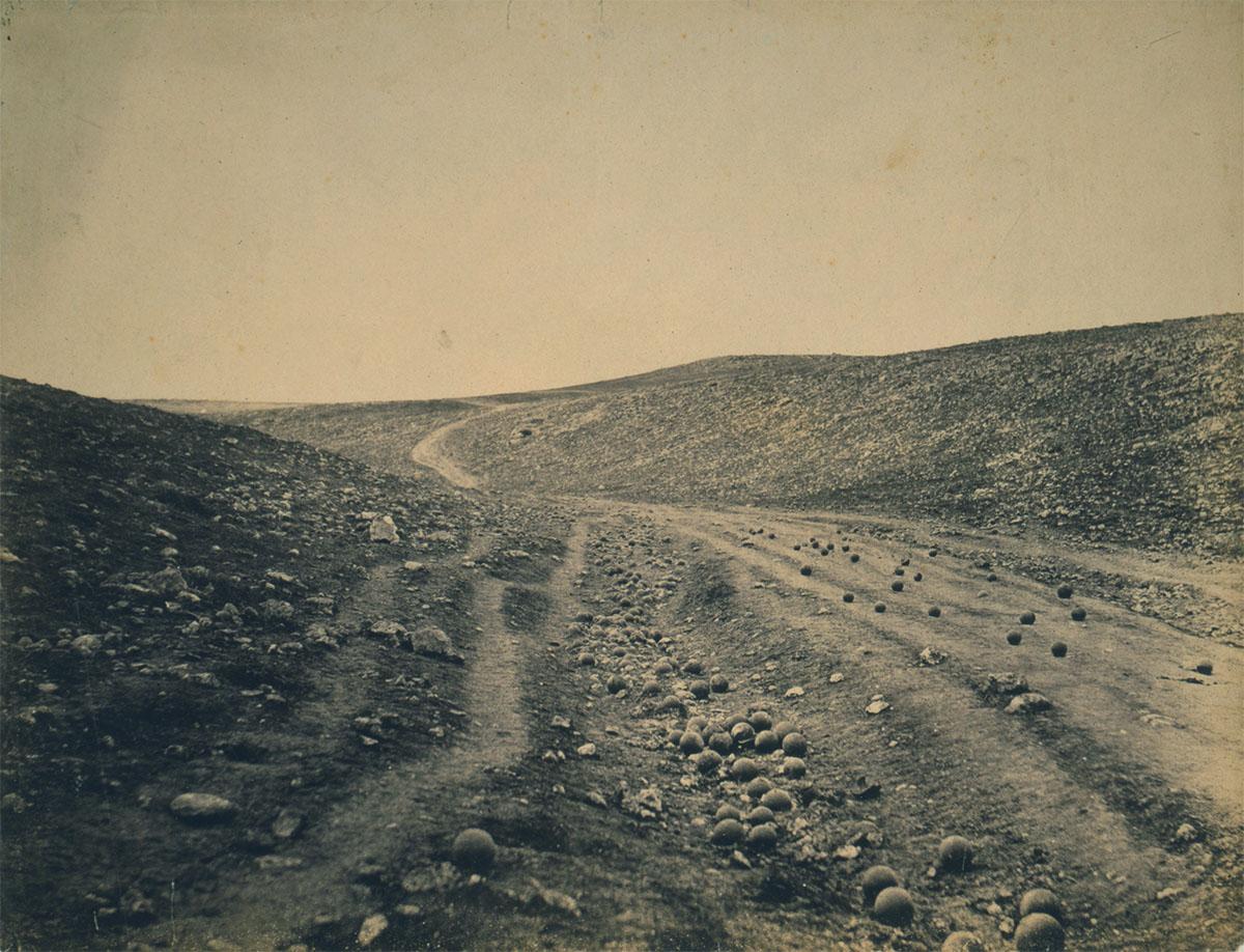 ”The valley of the shadow of death” Crimean War photograph. Dirt road in ravine scattered with cannonballs, 1855 - Library of Congress<p>© Roger Fenton</p>