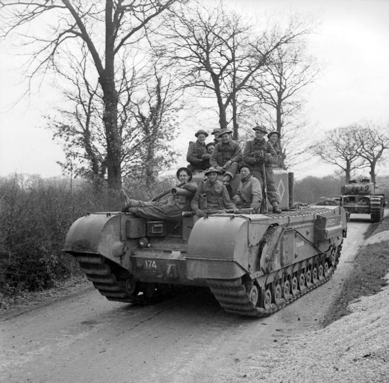 Canadian infantry riding on a Churchill III tank during Exercise ’Spartan’, 9 March 1943<p>© Bert Hardy</p>