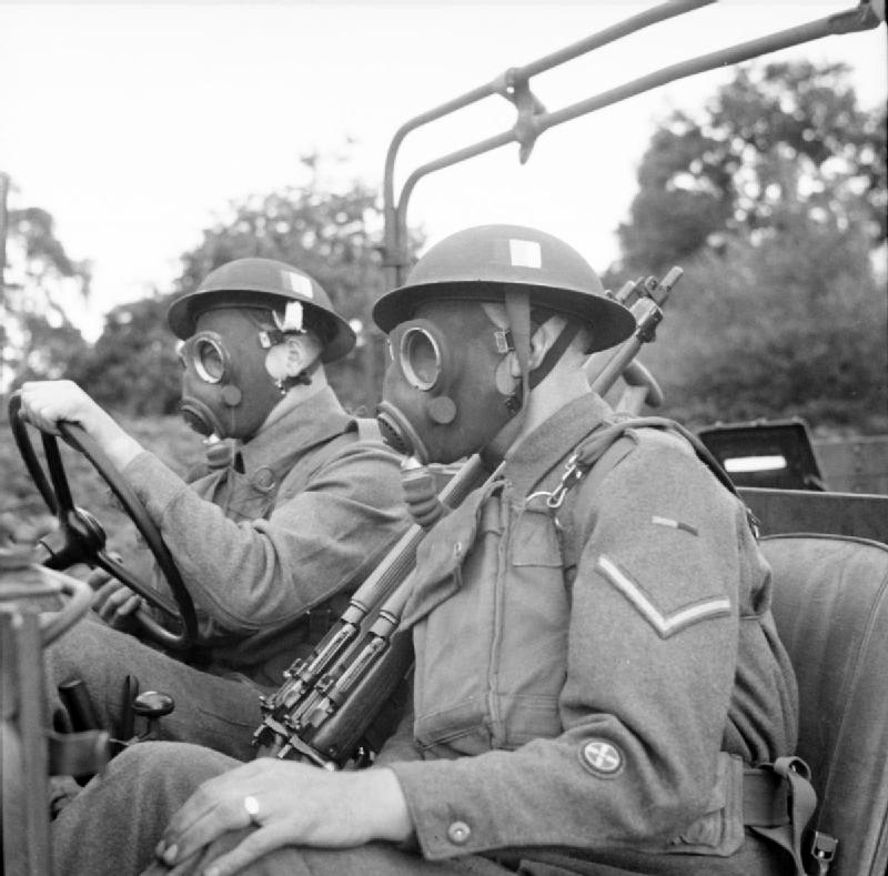 A trainee Army driver with an instructor learns how to drive in a gas mask. This and other photographs were part of a safety training exhibition organ<p>© Bert Hardy</p>