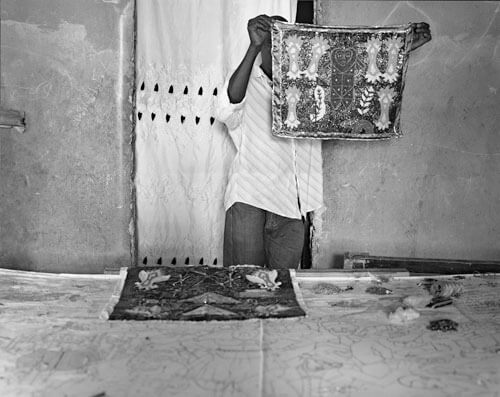 Wilfred Charles, (with one of Constant’s flags), Carrefour Feiulles, December 2011<p>© Laura Heyman</p>