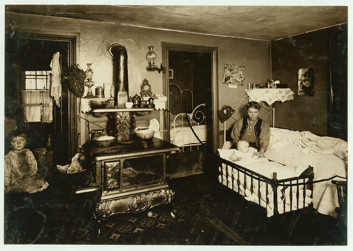 Overcrowded home of workers in cotton mill, Olneyville, Providence. Eight persons live in these three small rooms. 1912 © Library of Congress<p>© Lewis Hine</p>