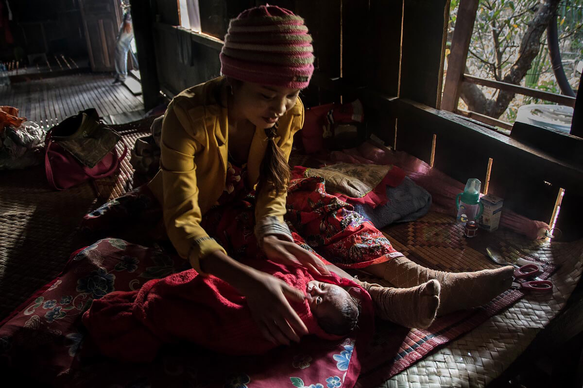 Mother with new-born child, on the Mekong, Cambodia.<p>© Rod Harbinson</p>