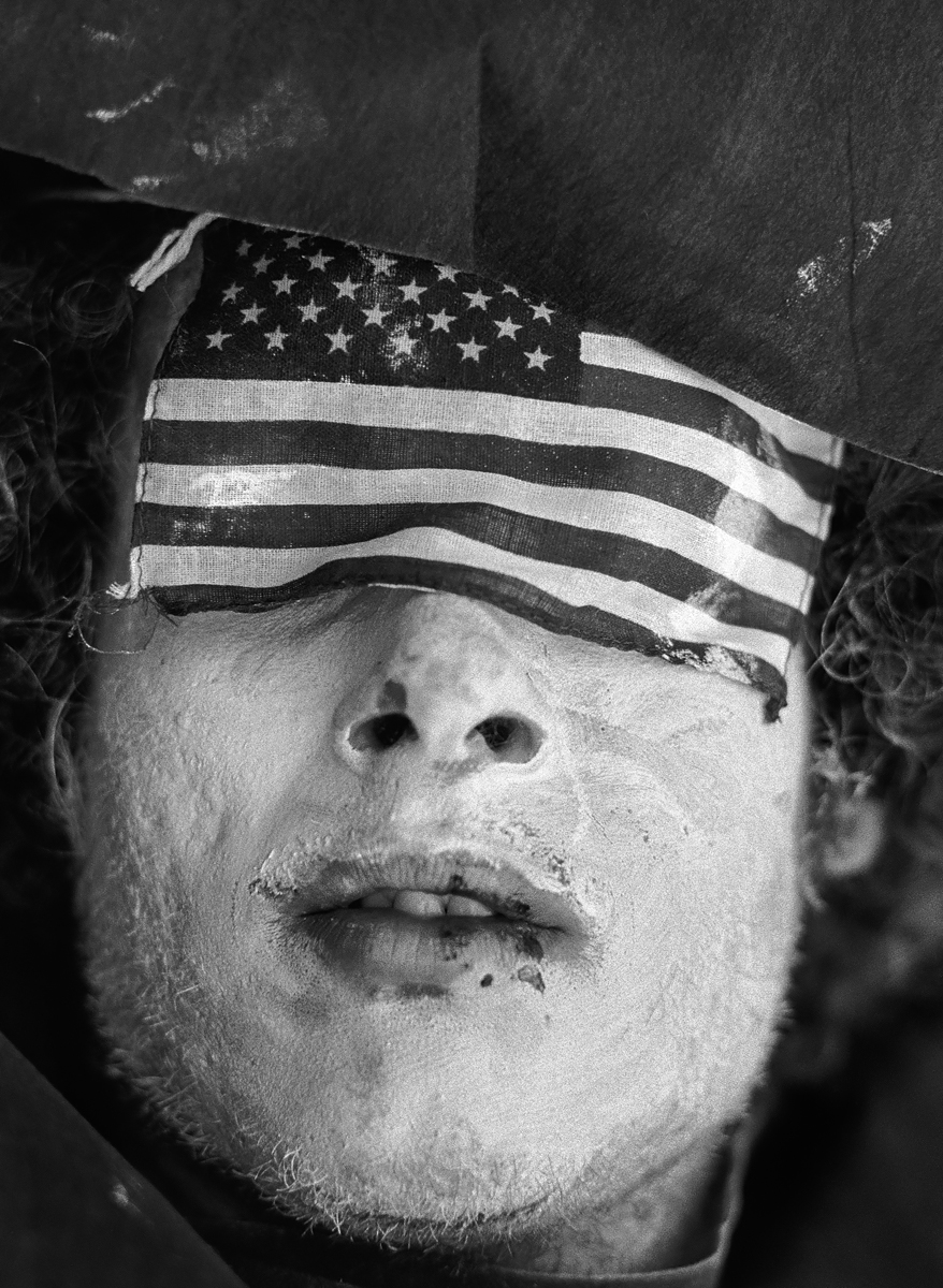 Photographer’s Paradise -  30th Republican Convention Miami FL 1972, Man with eyes covered with US Flag<p>© Jean-Pierre Laffont</p>