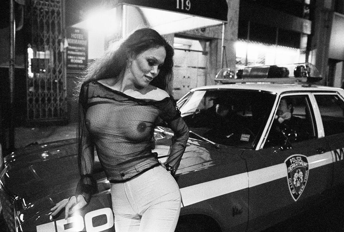 Photographer’s Paradise - NYC 42nd St. Prostitute on police car<p>© Jean-Pierre Laffont</p>