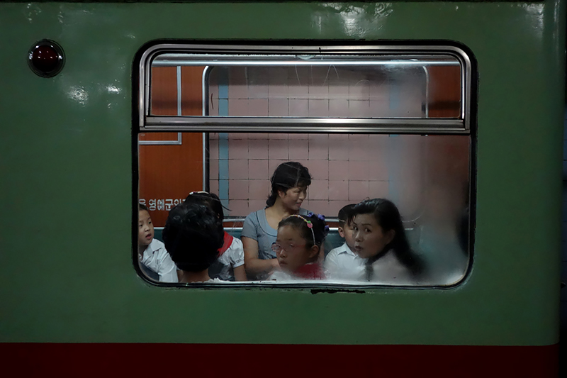 Commuters stare at Muir through the train window in the Pyongyang metro on August 20, 2014.<p>© Fabian Muir</p>