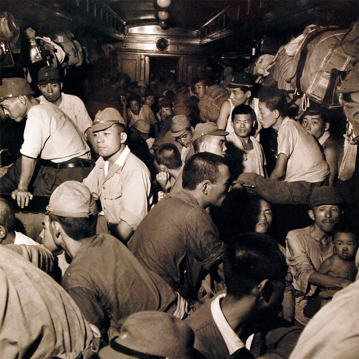 Demobilized Japanese soldiers and civilians aboard a train in Hiroshima, Japan, Sep 1945,  National Museum of the United States Navy<p>© Wayne Miller</p>