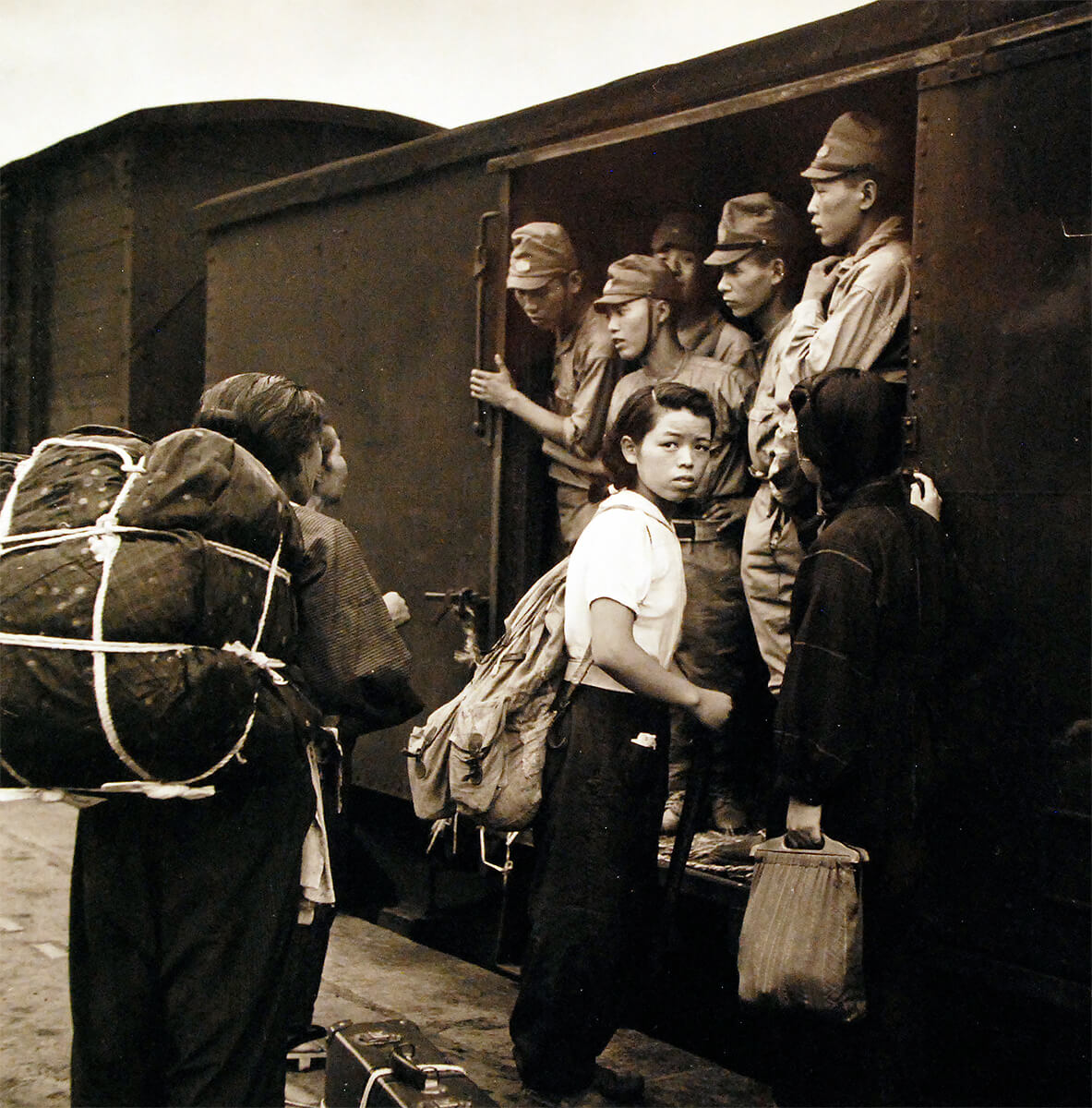 Japanese soldiers and civilians at a train station, Hiroshima, Japan, Sep 1945,  National Museum of the United States Navy<p>© Wayne Miller</p>