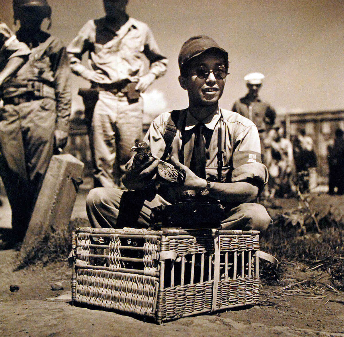 Japanese photographer T. Iwamoto attaching film of surrender of Yokosuka Navy Base to a pigeon for transport to Domeo News Agency in Tokyo, Japan, Aug<p>© Wayne Miller</p>