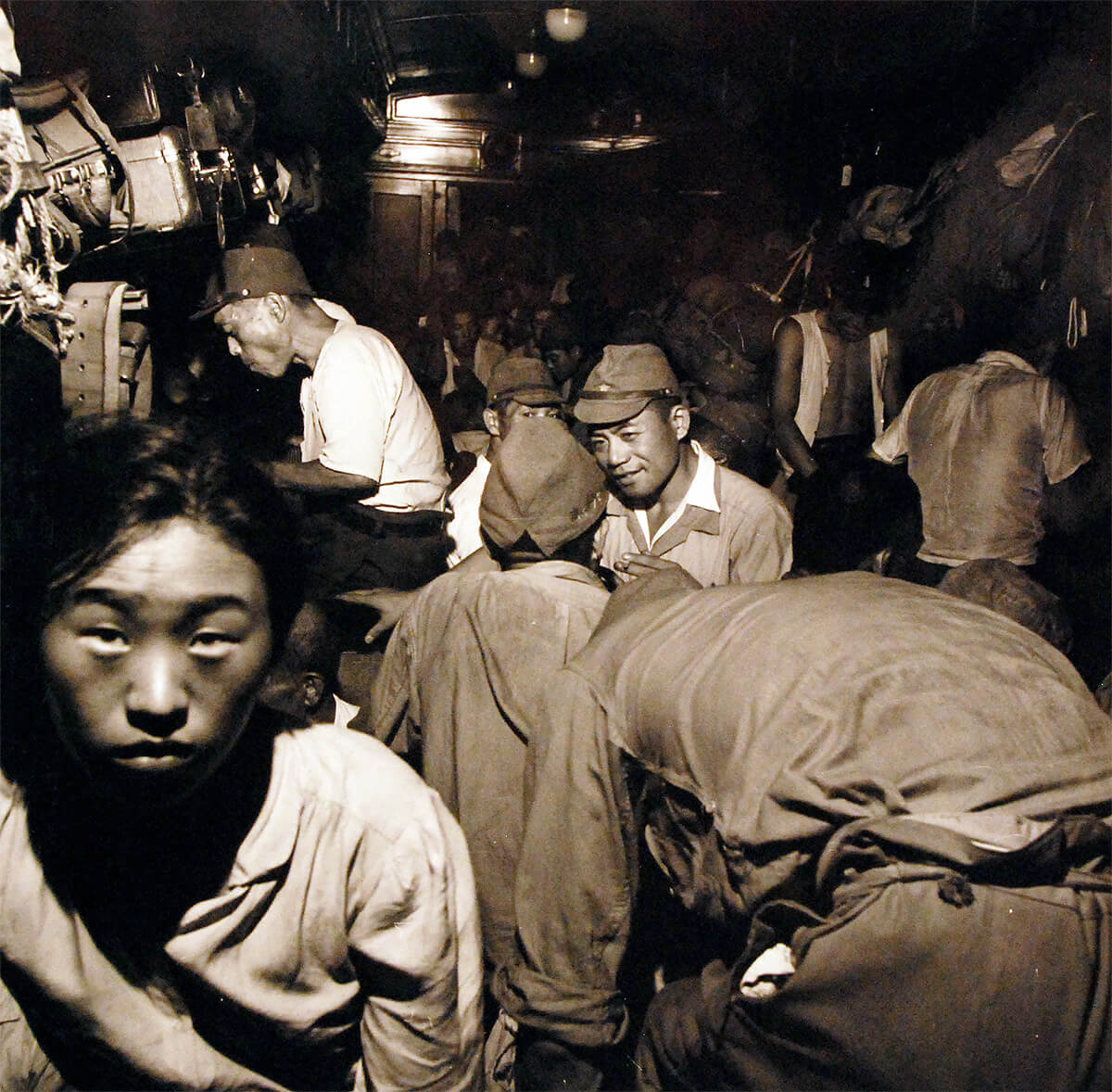 Demobilized Japanese soldiers and civilians aboard a train in Hiroshima, Japan, Sep 1945,  National Museum of the United States Navy<p>© Wayne Miller</p>