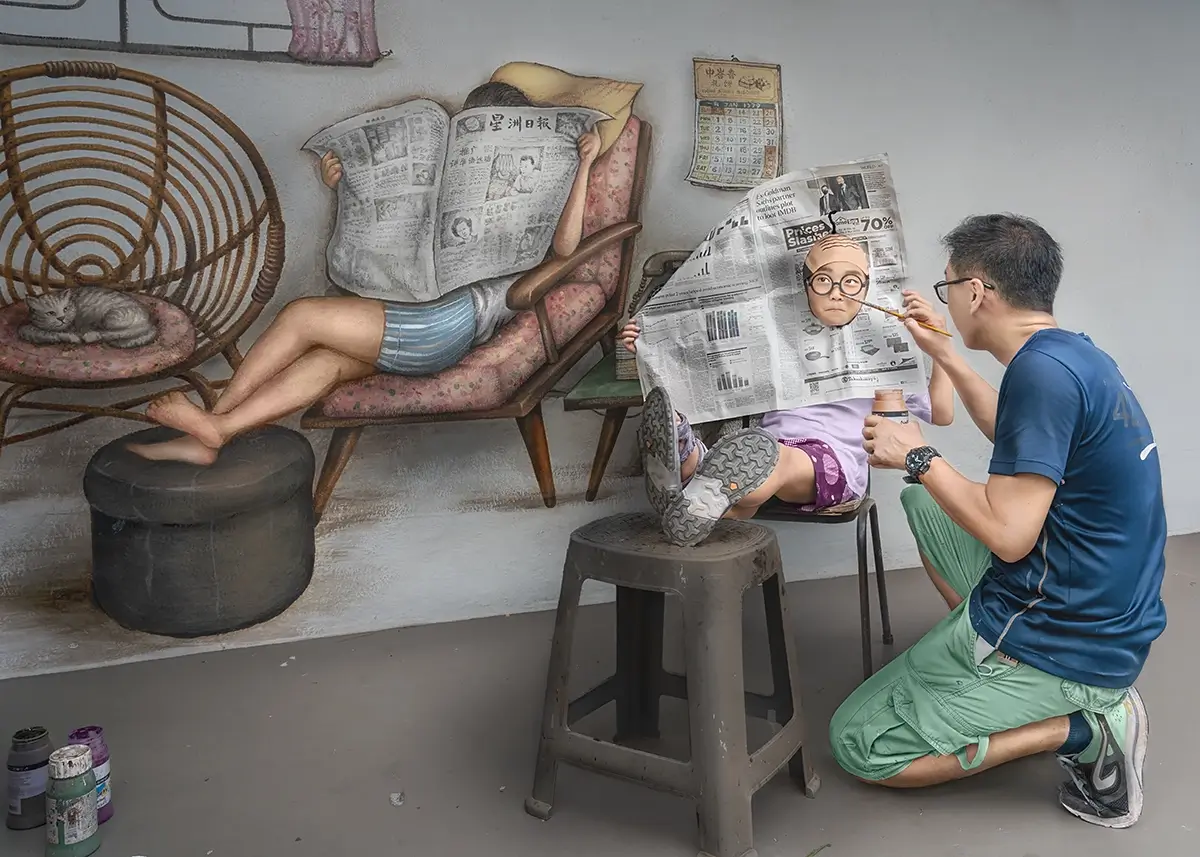 The Prince Who Joined the Wall: Seated near the mural by Mr. Yip, the Prince lifted a newspaper, folding himself into paint. He blurred the line betwe<p>© Kantaya New</p>