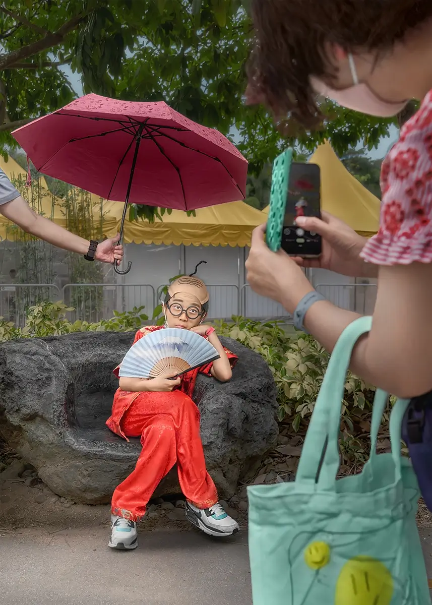 The Prince Who Sat Like a King: Dressed in red and shaded by a pink umbrella, the Prince posed with quiet pride. No throne needed—just an audience.<p>© Kantaya New</p>