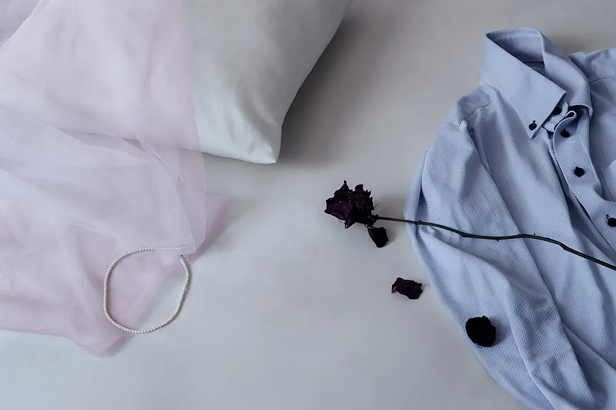 The Remains: Her bed, still made. A shirt, a pearl, a dead rose—What is left behind says enough.<p>© Kantaya New</p>