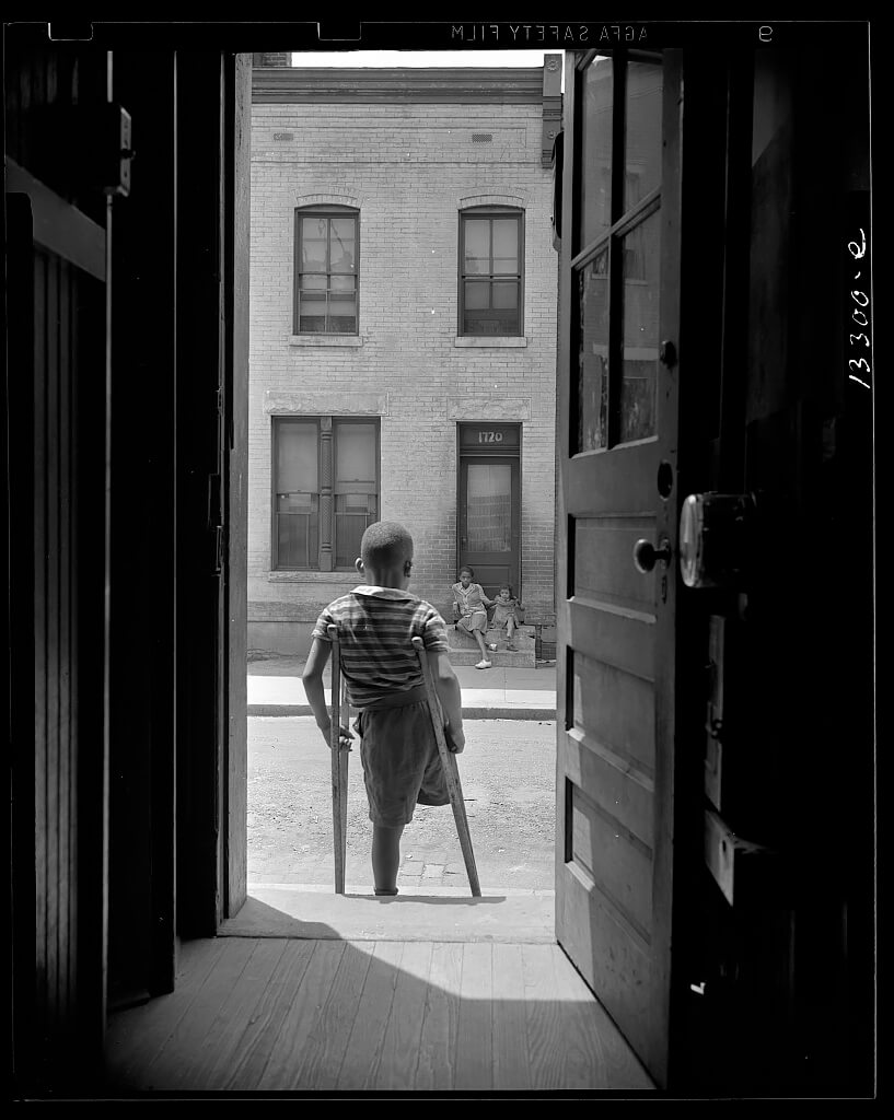 Washington, D.C. Young boy standing in the doorway of his home on Seaton Road in the northwest section. 1942<p>© Gordon Parks</p>