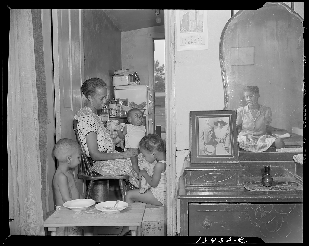 Mrs. Ella Watson, a government charwoman, with three grandchildren and her adopted daughter 1942<p>© Gordon Parks</p>