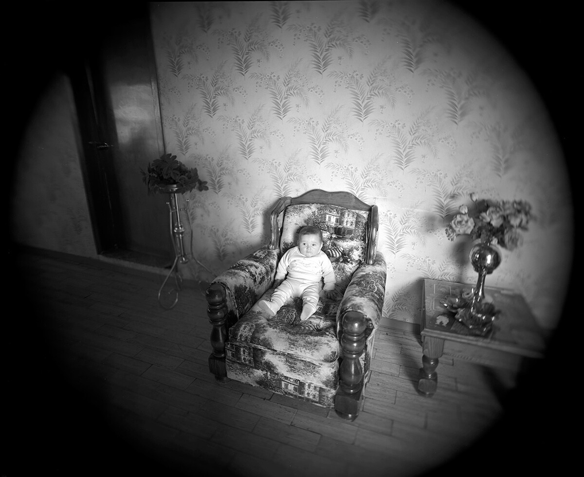 Plump baby on overstuffed chair<p>© Meg McKenzie Ryan</p>