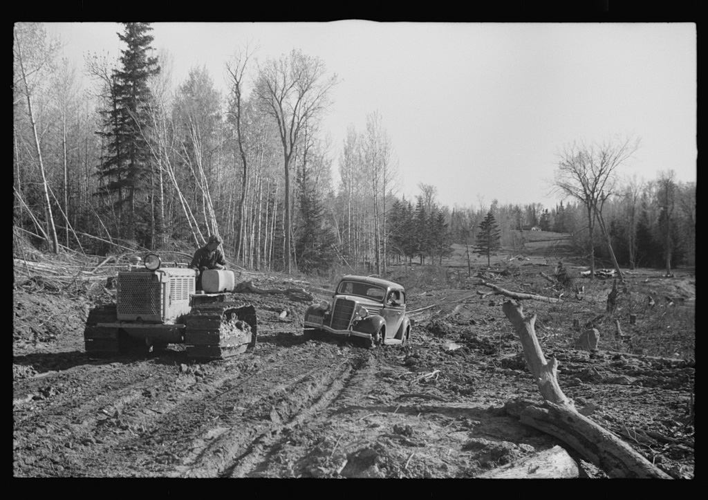 FSA (Farm Security Administration) photographer being pulled out of mud by tractor, near Littlefork, Minnesota, c. 1937 @ Library of Congress<p>© Roy Stryker</p>