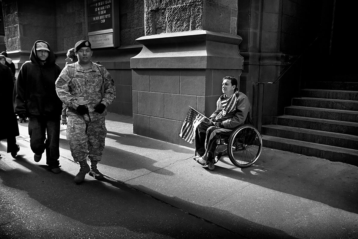 Man in Wheelchair with Flag, New York, NY, 2012<p>© Robert Virga</p>
