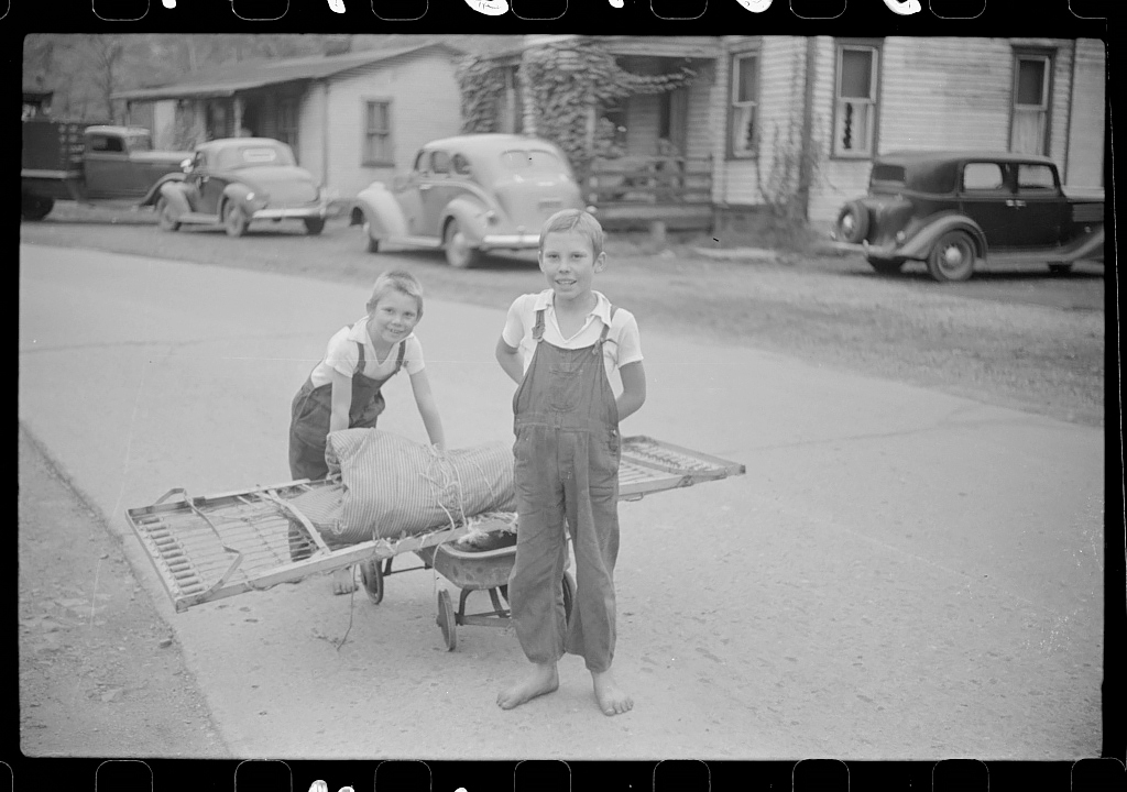 Children taking home remains of a bed. Coal mining camp, Scotts Run, West Virginia, 1938<p>© Marion Post Wolcott</p>