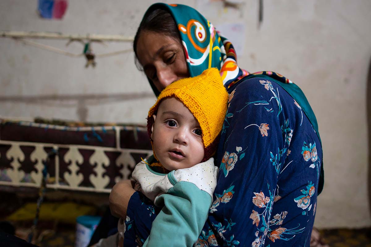 Kasra looks at the camera in her mother’s arms. Amir Ayyub, Fars Province, Iran, January 2021.<p>© Sajedeh Zarei</p>