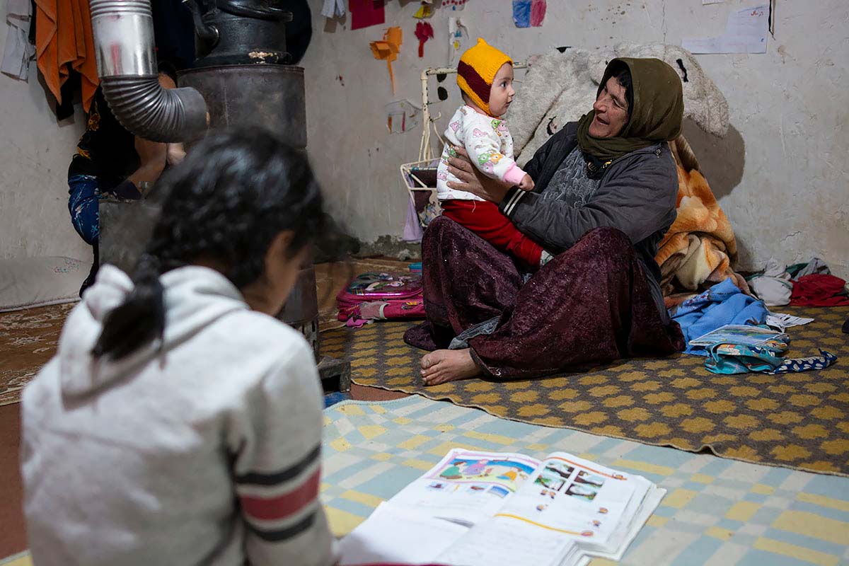 Grandmother is playing with Kasra. Behavior of other family members is discriminatory and Asma is concerned about Mahsa. Amir Ayyub,Iran,January 2021.<p>© Sajedeh Zarei</p>