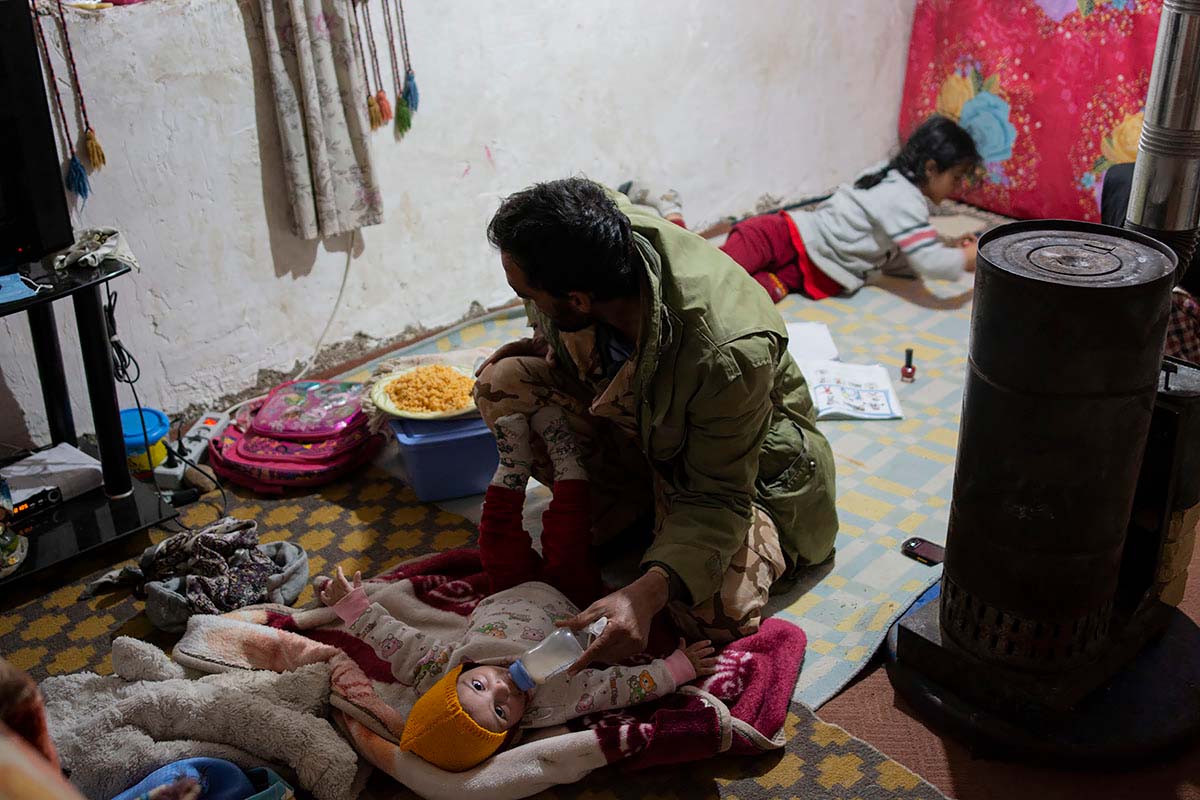 Mohsen is feeding milk to Kasra. He participates in the work; however, they face opposition and ridicule from other families. Iran, January 2021.<p>© Sajedeh Zarei</p>