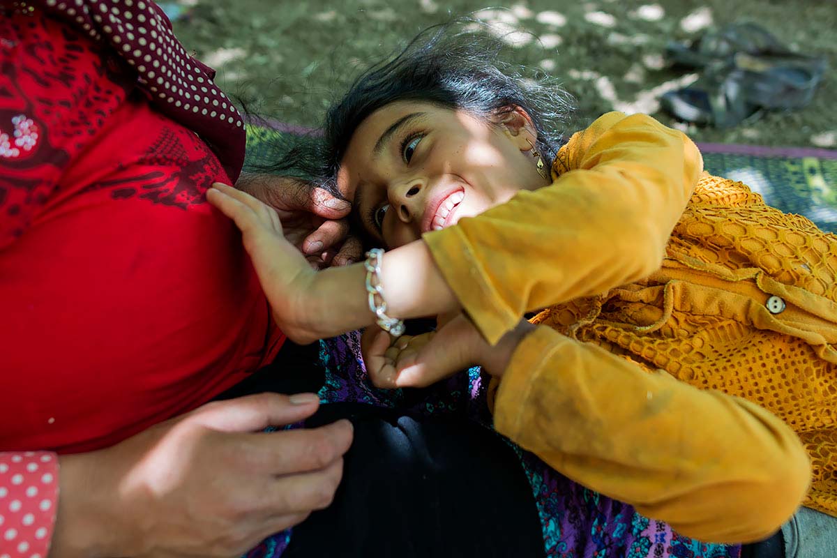 Asma is 8 months pregnant and Mahsa is talking to her brother in her mother’s womb. She is very eager for her brother. Ab-zardi, Iran, June 2020.<p>© Sajedeh Zarei</p>