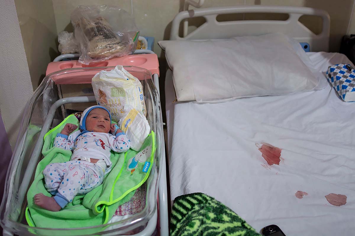 Newborn baby, Kasra, in the hospital. Asma’s husband did not accompany her because the leopard attacked the herd. Gachsaran, Iran, August 2020.<p>© Sajedeh Zarei</p>